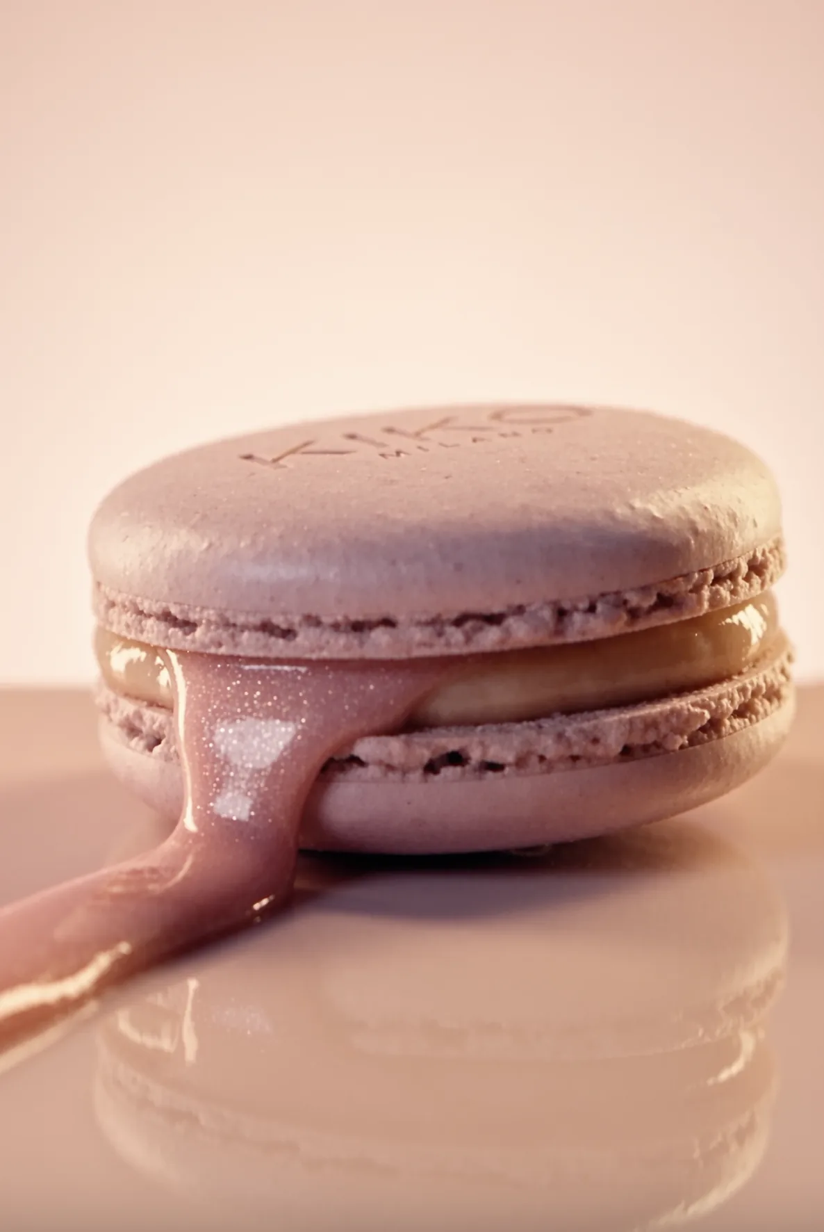 Macaron with pink gloss melting over it