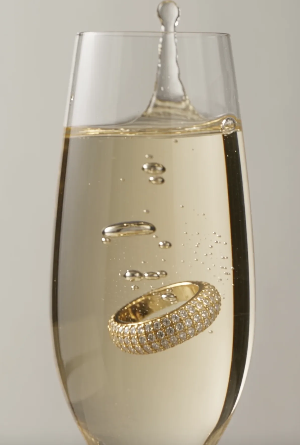 Diamond ring sinking in a glass of champagne