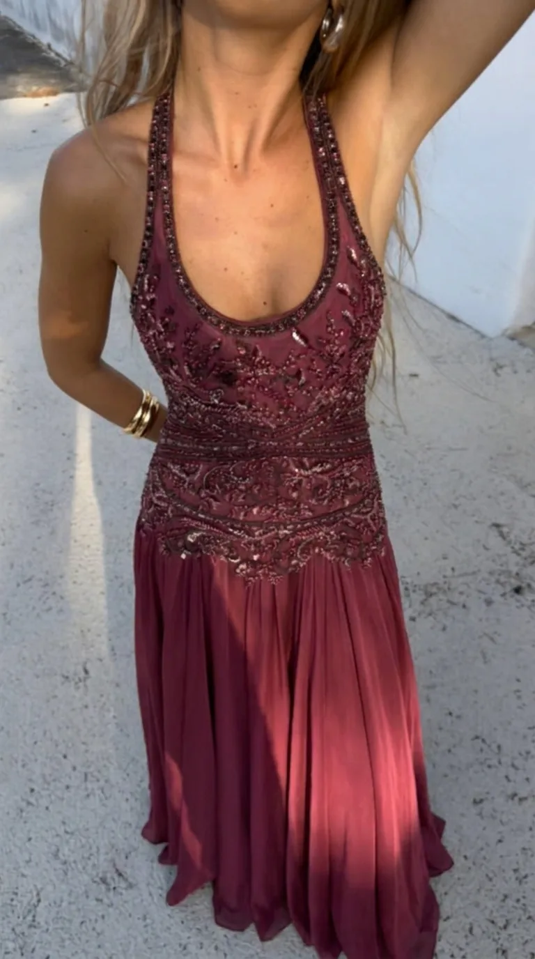 Burgundy beaded halter gown in sunlight
